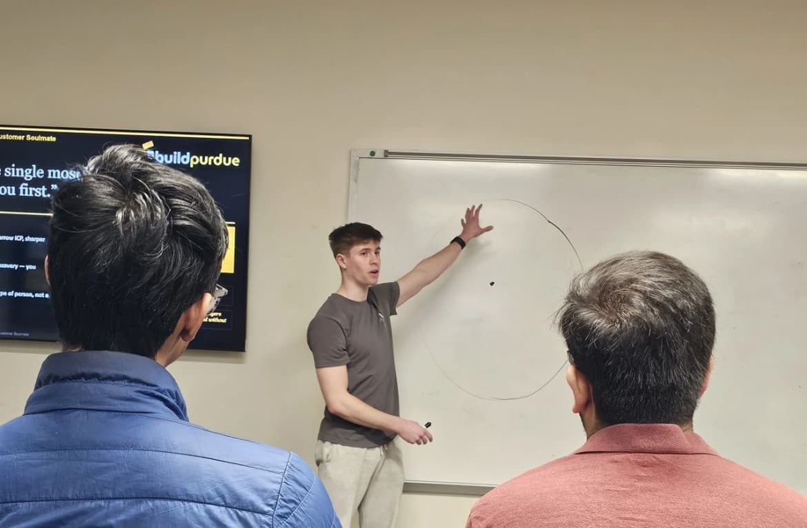 A Cohort founder explaining an idea at a whiteboard