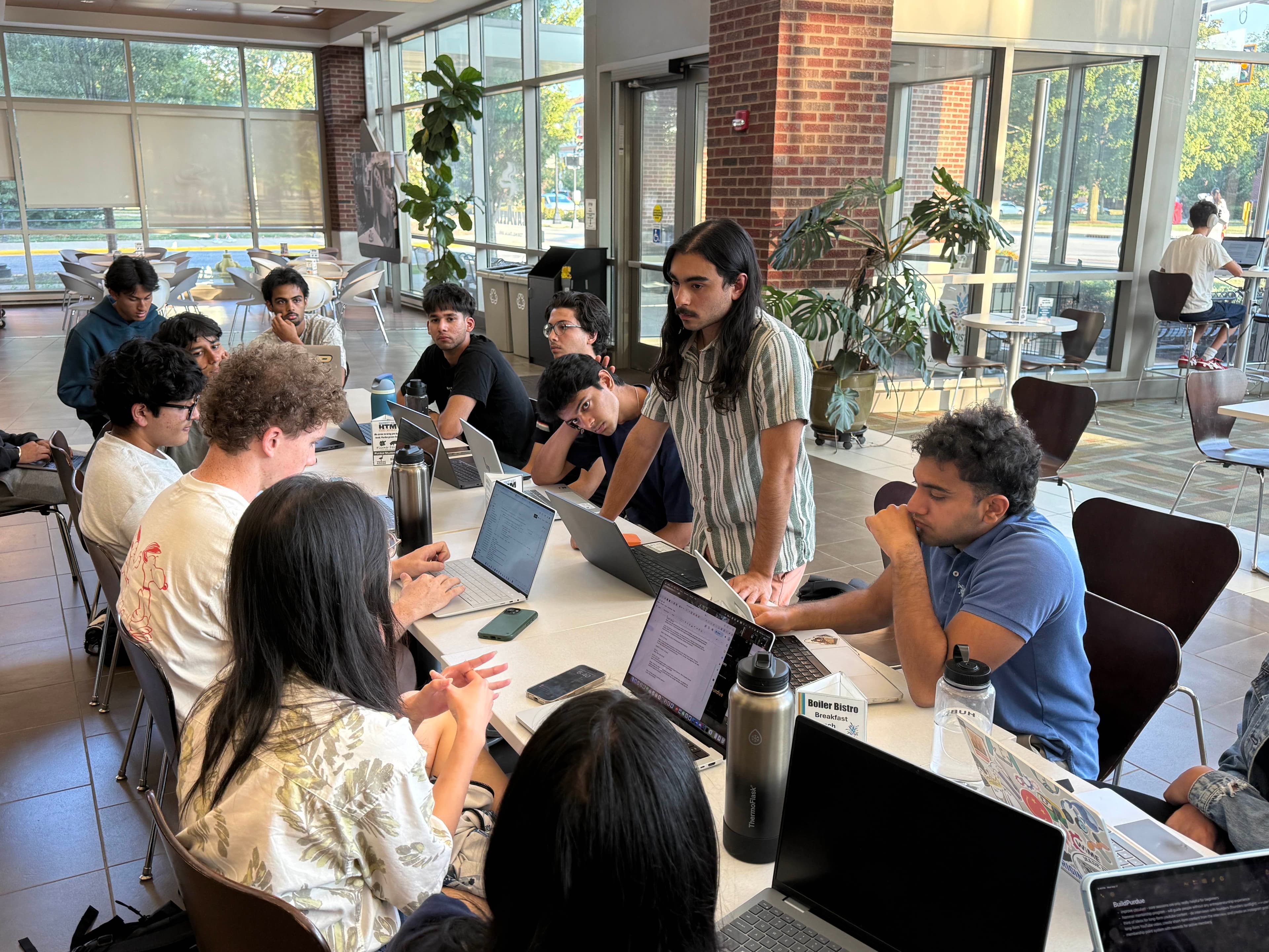 Student founders working together around a table